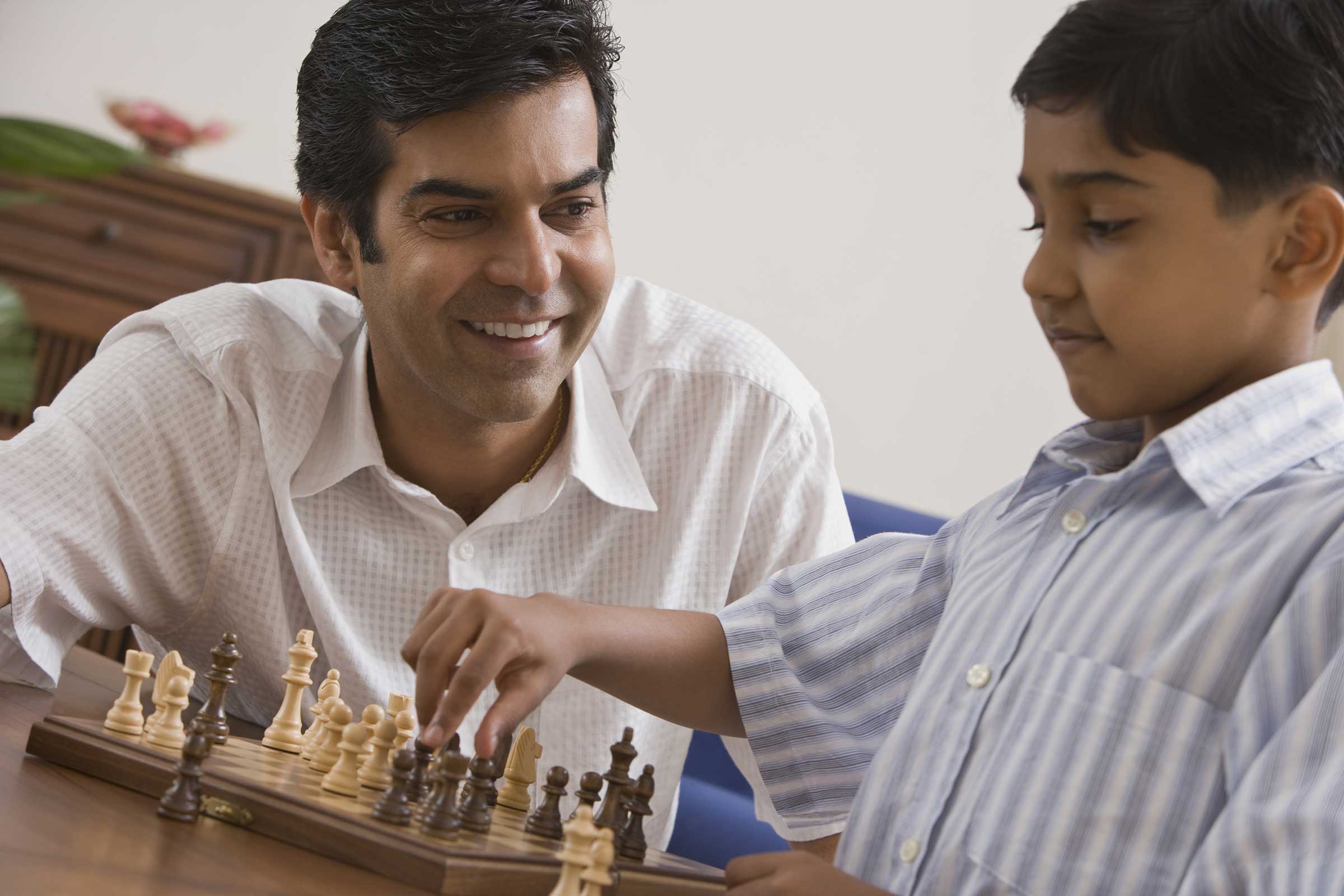 Man and boy playing chess