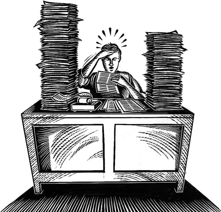 Image of a man at a desk working on a pile of paperwork.