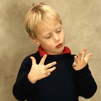 Photo of a boy counting on his fingers.