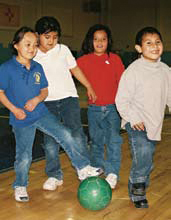 Photo of children playing with a soccer ball.