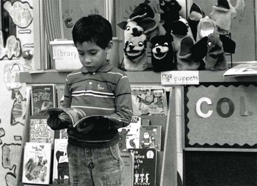 Child reading at a resource center.