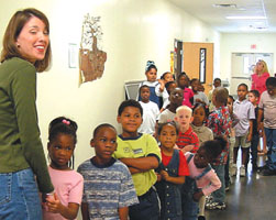 Lisa Parks waits with her first-graders for their turn in the cafeteria.